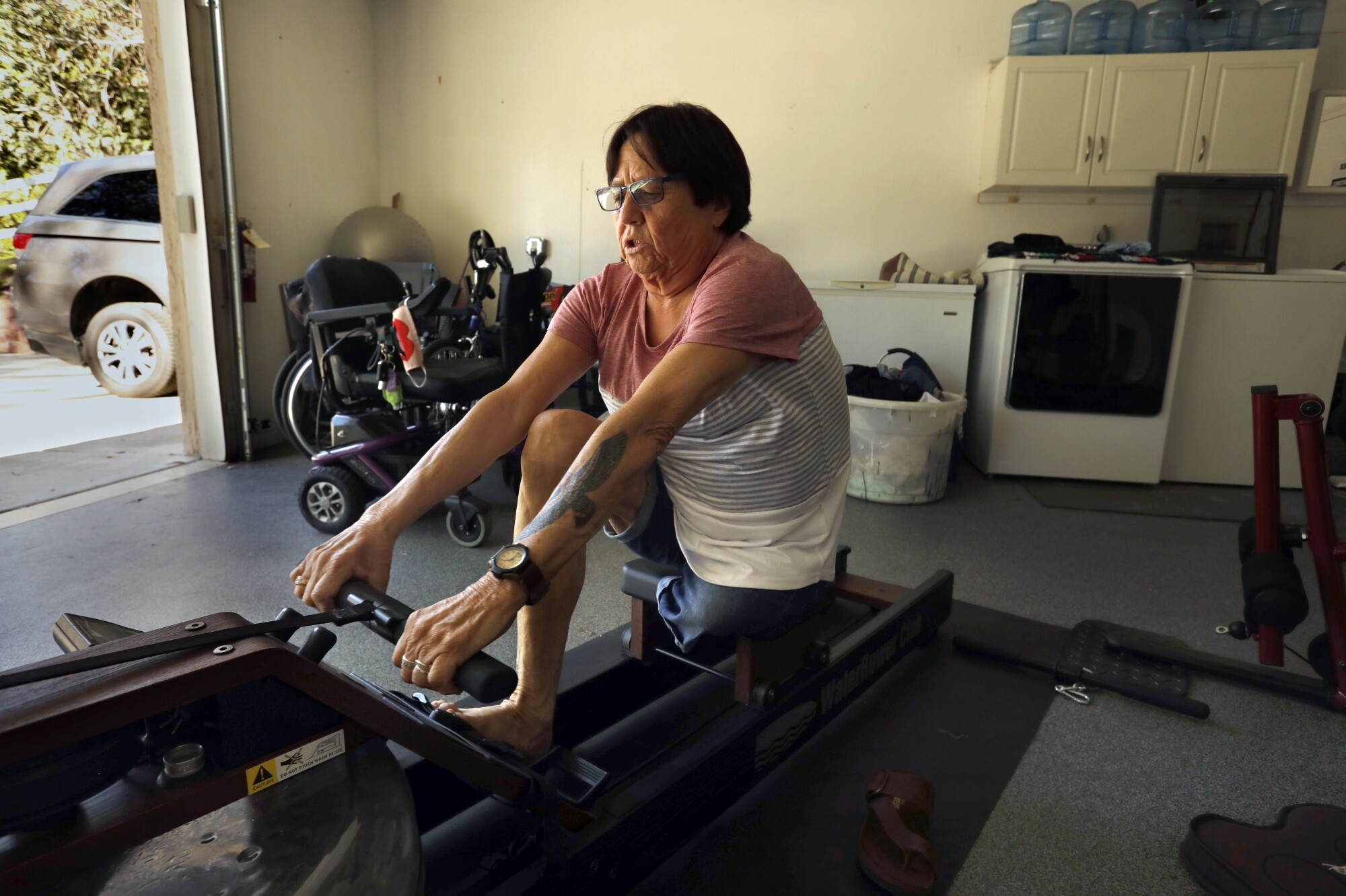 A woman works out in her garage