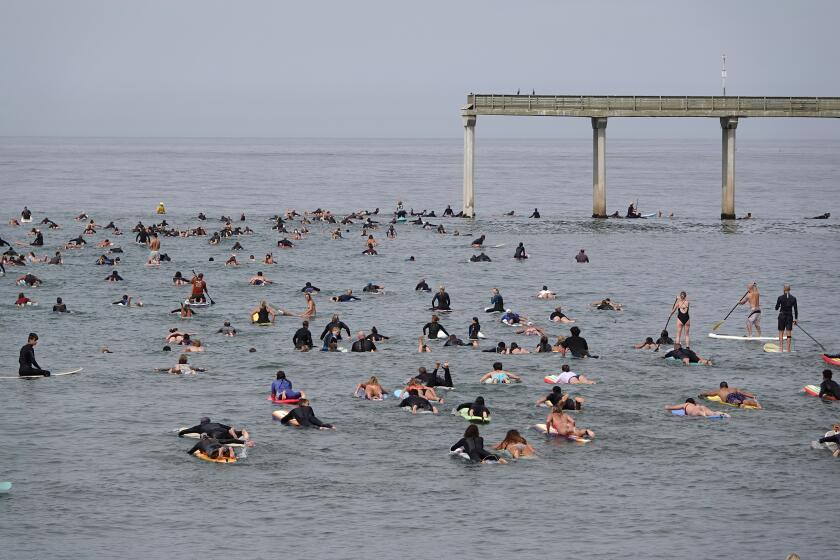 San Diego, CA - OCTOBER 3: People head out for the Surfrider Foundation San Diego County's 29th annual Paddle for Clean Water in Ocean Beach on Sunday, Oct. 3, 2021. The group paddled around the Ocean Beach pier to show solidarity for the protection of the coastline. (K.C. Alfred / The San Diego Union-Tribune)