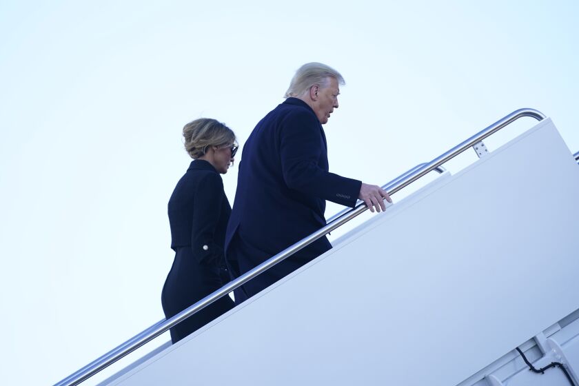President Donald Trump and first lady Melania Trump board Air Force One at Andrews Air Force Base, Md., Wednesday, Jan. 20, 2021.(AP Photo/Manuel Balce Ceneta)