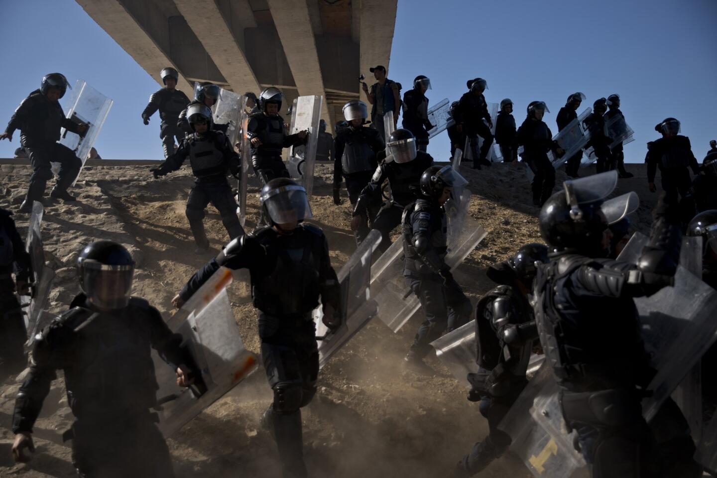 Migrants try to cross border at Tijuana