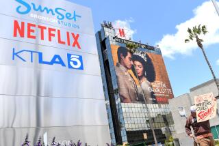 A screenwriter on strike walks by the Netflix sign on Sunset Blvd, on May 02, 2023 in Los Angeles, California. - More than 11,000 Hollywood television and movie writers went on their first strike in 15 years, after talks with studios and streamers over pay and working conditions failed to clinch a deal. The strike means late-night shows are expected to grind to a halt immediately, while television series and movies scheduled for release later this year and beyond could face major delays. (Photo by VALERIE MACON / AFP) (Photo by VALERIE MACON/AFP via Getty Images)