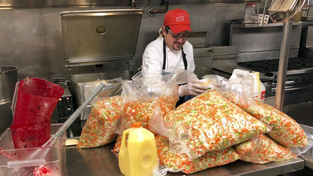 Mick Zalis oversees preparations for a Thanksgiving dinner on the Cal State Chico campus for people displaced by the Camp fire.