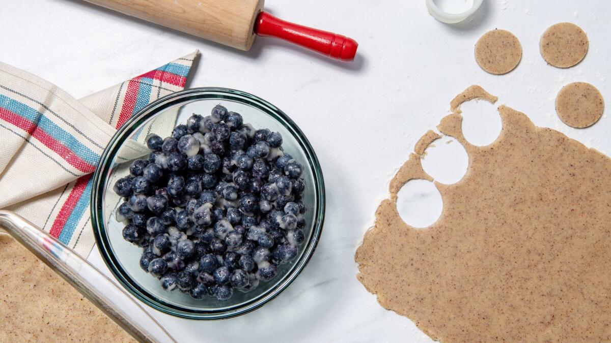 Roll and cut the dough into decorative shapes for the top to go over the easy one-bowl berry filling.