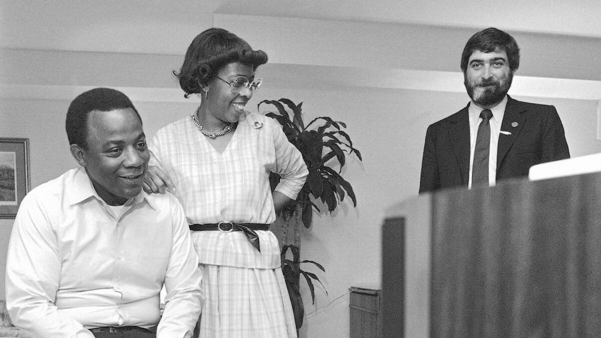 W. Wilson Goode and wife Velma smile as they react to the news on television of a heavy black voter turn out in west Philadelphia in the Democratic primary election at the Philadelphia Centre Hotel on May 17, 1983. Patrick Caddell is on the right.