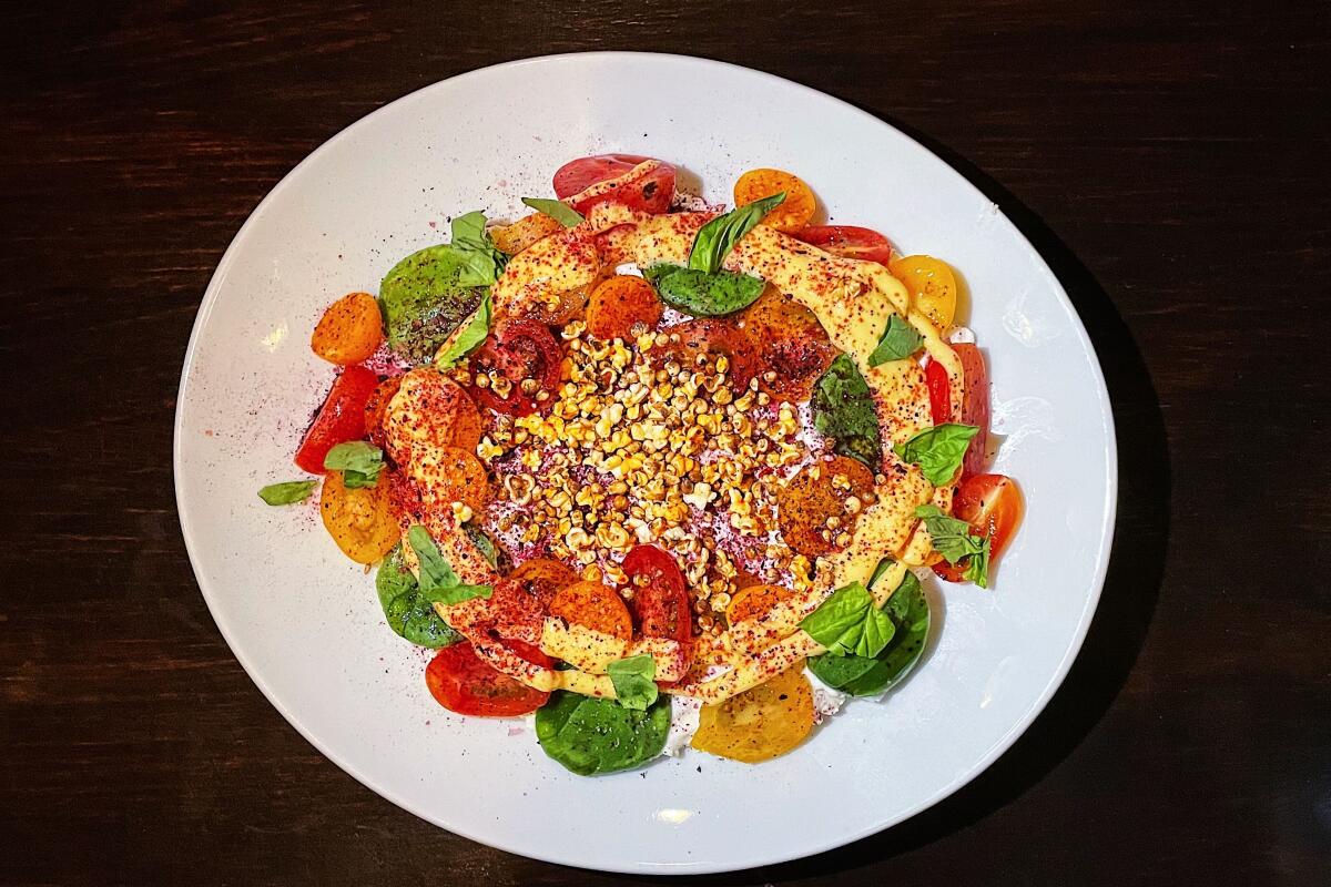 The "noprese" salad, which adds nopales, or cactus, and hibiscus salt to a classic caprese, at Amiga Amore in Highland Park.