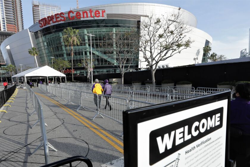 A slow trickle of fans head toward the Staples Center entrance for the Lakers-Celtics game on April 15, 2021.