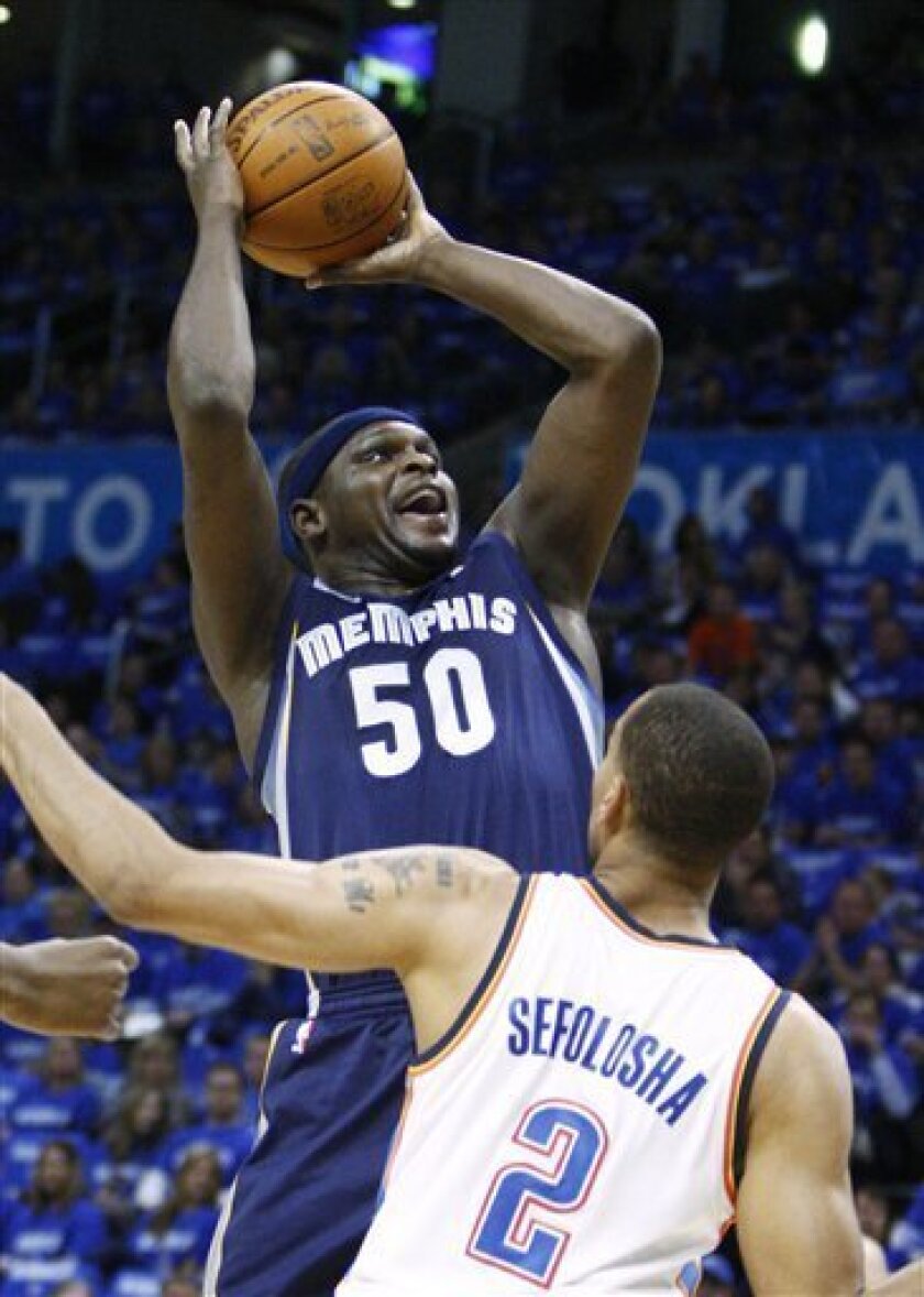 Memphis Grizzlies forward Zach Randolph, left, shoots in front of Oklahoma City Thunder guard Thabo Sefolosha, right, of Switzerland, in the first quarter of Game 1 of a second-round NBA basketball playoff series in Oklahoma City, Sunday, May 1, 2011. (AP Photo/Alonzo Adams)