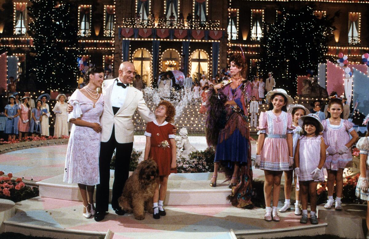 Albert Finney, Aileen Quinn, Carol Burnett and others on stage in scene from the film "Annie."