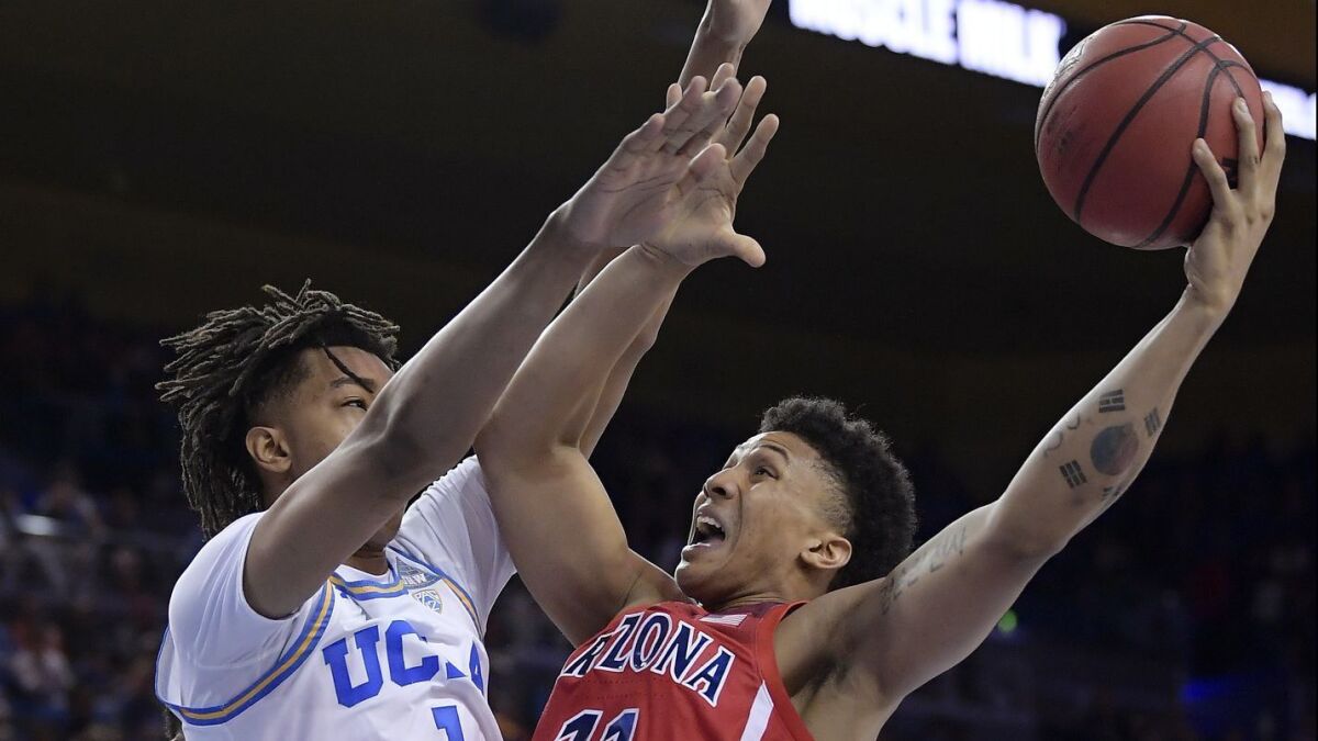 Arizona forward Ira Lee, right, shoots as UCLA center Moses Brown defends during the first half on Saturday at Pauley Pavilion.