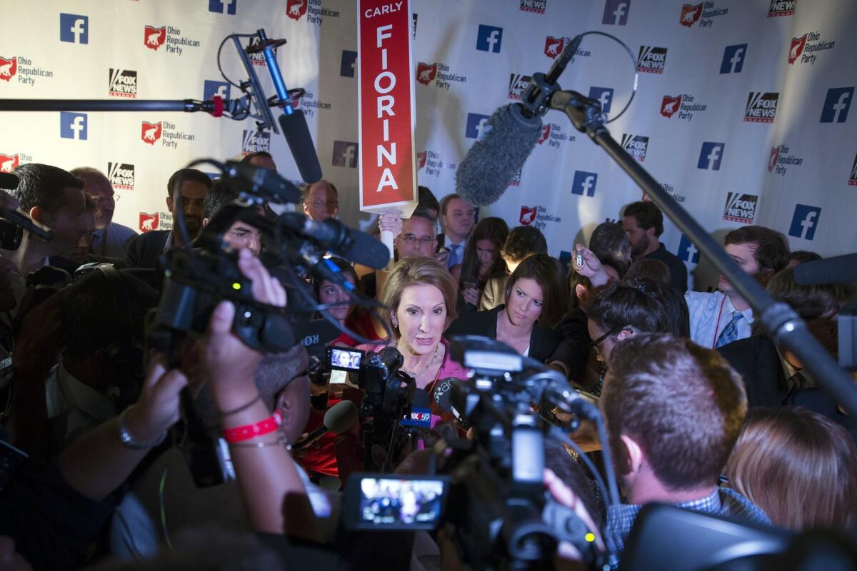 Republican presidential candidate Carly Fiorina speaks to the media in the spin room after a pre-debate forum at the Quicken Loans Arena, Thursday, Aug. 6, 2015, in Cleveland. Seven of the candidates have not qualified for the primetime debate. (AP Photo/John Minchillo)