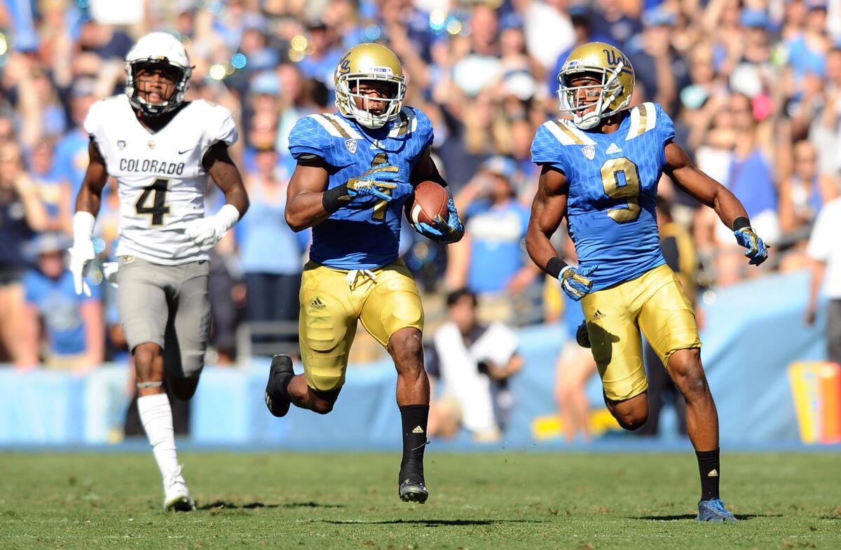 UCLA defensive back Ishmael Adams intercepts a pass in the end zone and returns it for a touchdown against Colorado during a game at the Rose Bowl on Oct. 31.