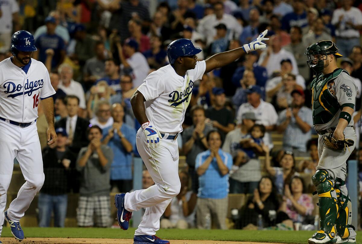 Dodgers outfielder Yasiel Puig heads to the dugout after hitting a two-run homer against the Athletics during the fourth inning of a game on July 29.