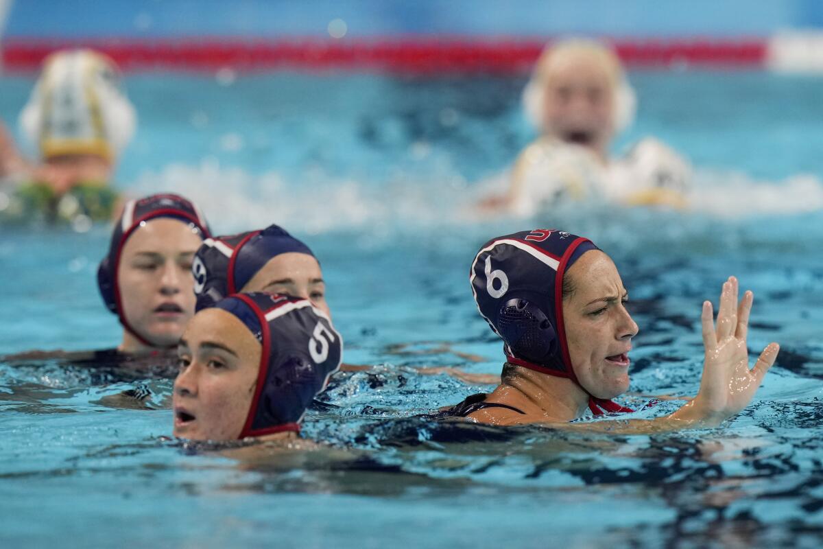 American water polo players react after losing a penalty shootout during a semifinal match