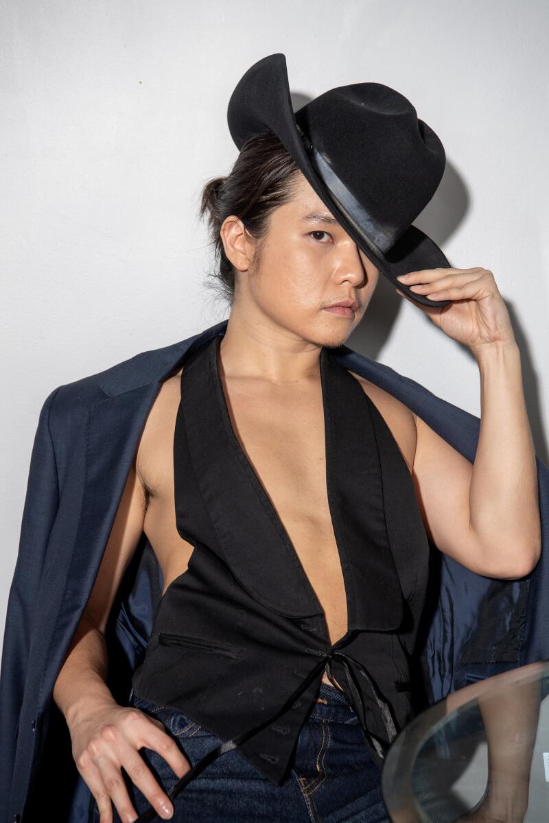 Bin wears archival Roberto Cavalli for H&M vest, Levi’s pants, Stetson cowboy hat, Acne Studios boots.