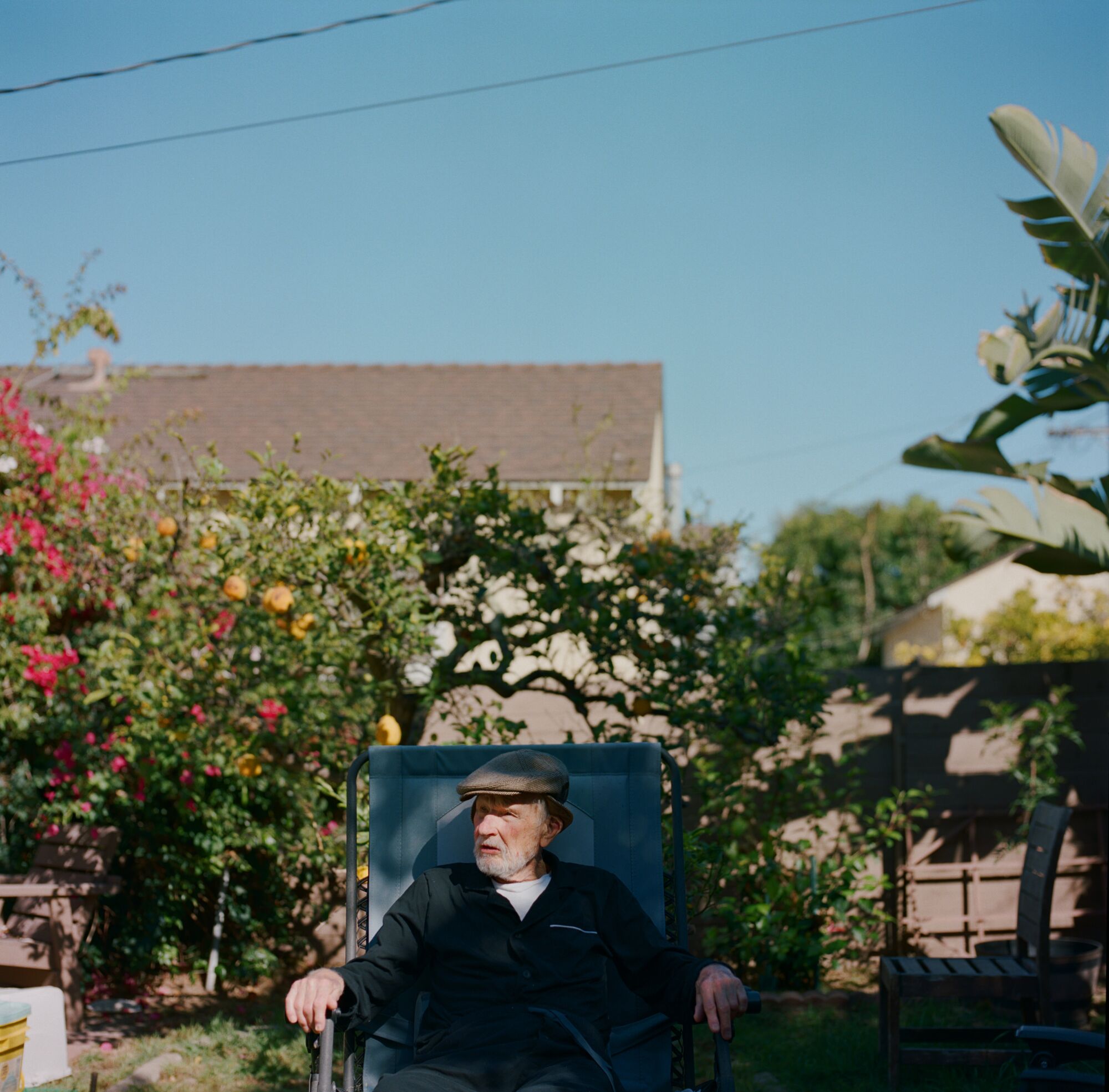 Andrzej sits in his backyard on a September afternoon.