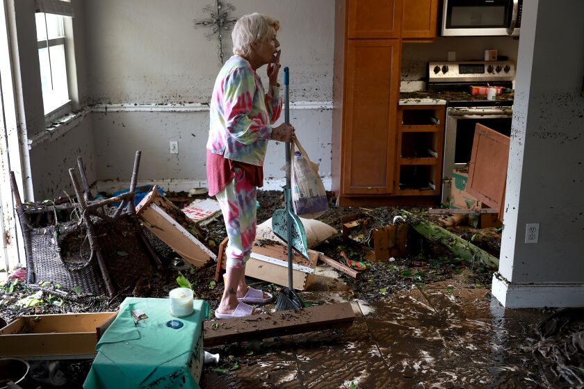Stedi Scuderi looks over her apartment after flood water inundated it when Hurricane Ian passed through the area.