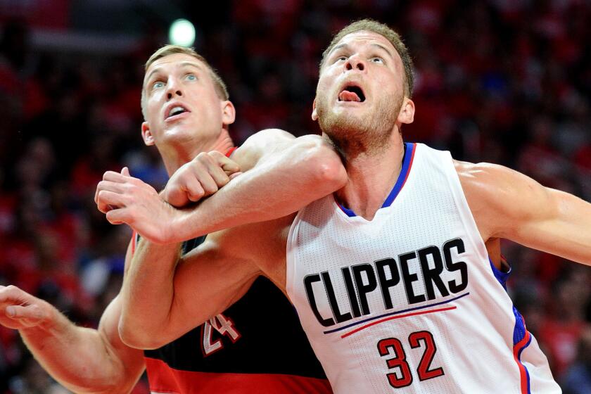 Clippers power forward Blake Griffin battles for rebounding position with Trail Blazers center Mason Plumlee in the first half of a playoff game last season.