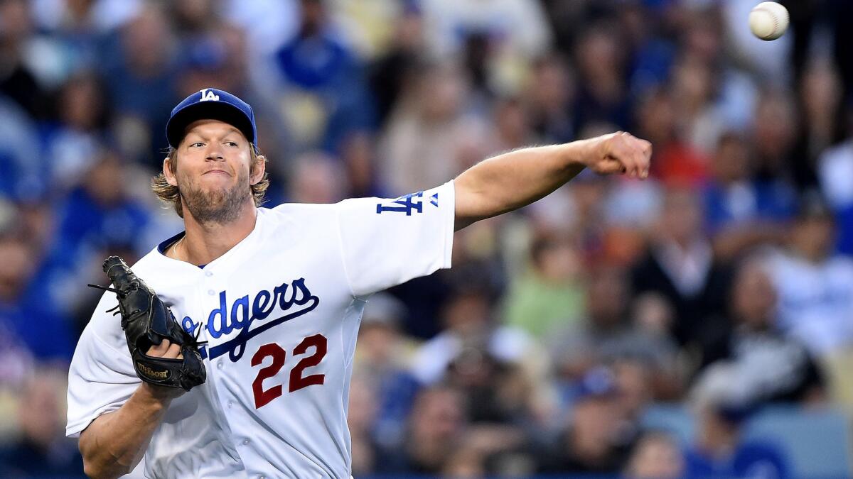 Dodgers starter Clayton Kershaw makes a throw to first base to put out a batter during a game against the Atlanta Braves on May 26 at Dodger Stadium.