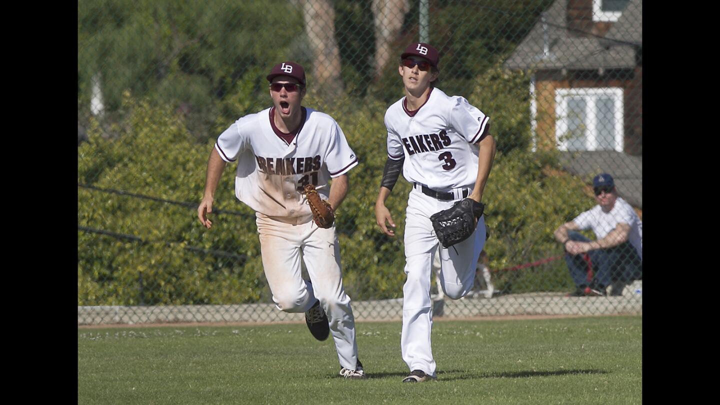 Laguna's Grady Morgan and Will Bonn, from left, run off the field after Bonn's leaping catch to end the inning during second round of the CIF Southern Section Division 2 playoffs against Newbury Park on Tuesday.