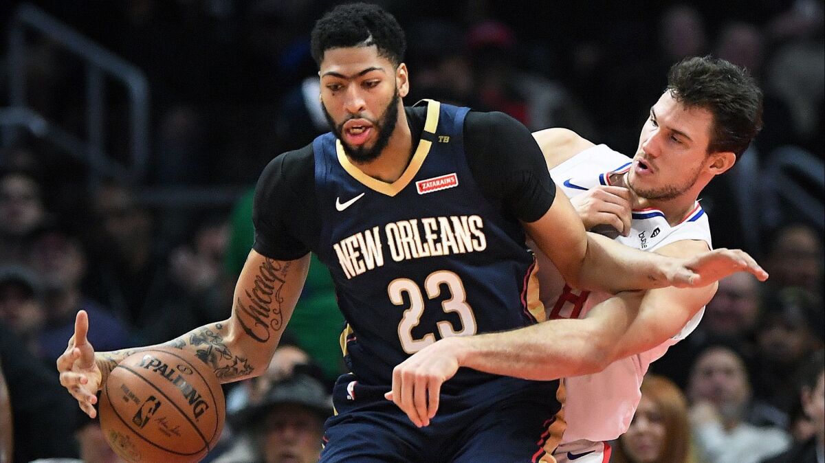 Clippers' Danilo Gallinari hounds Pelicans' Anthony Davis in the first quarter at the Staples Center.