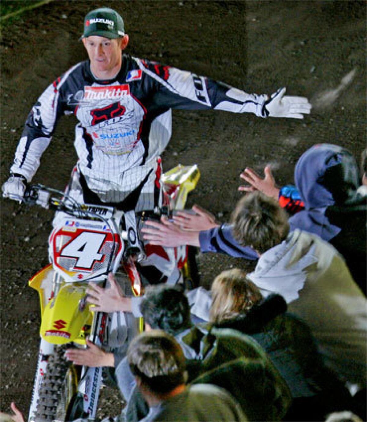 Ricky Carmichael greets fans at Angel Stadium. The 27-year-old will be giving NASCAR a try, and James Stewart, who defeated Carmichael on Saturday, is an heir apparent in a sport whose racers fly faster, farther and higher than anyone thought possible just two years ago.
