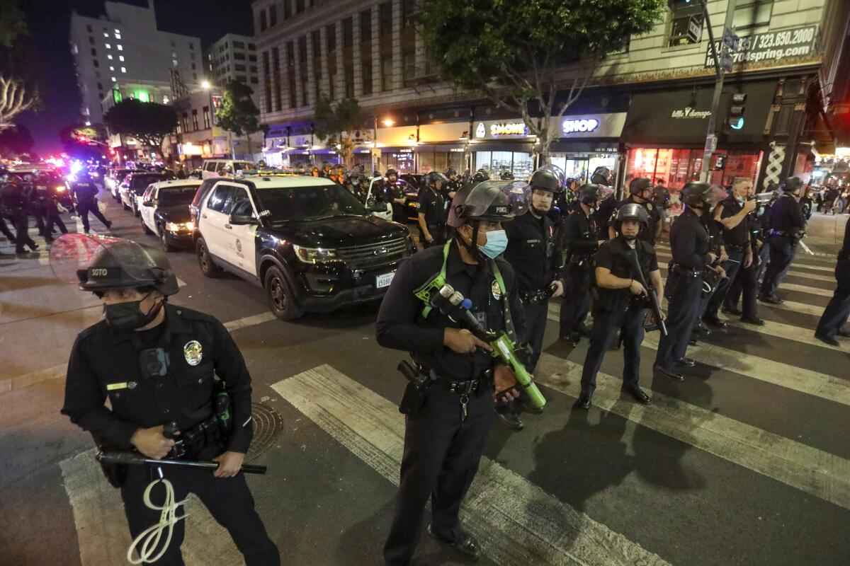 LAPD officers try to control a crowd in downtown Los Angeles 