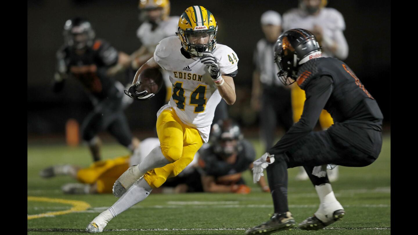 Edison High's Tanner Nelson (44) carries the ball during the first half against Huntington Beach in a Sunset League game in Huntington Beach on Thursday, Oct. 05.