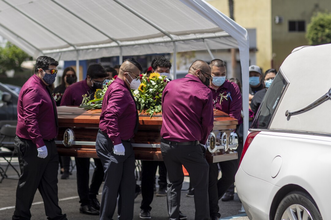 Casket of Felipe Juarez is loaded on a hearse 