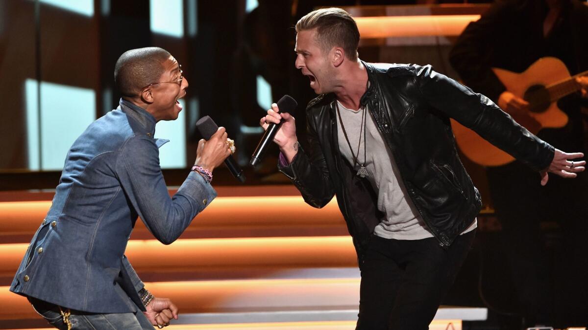 Ryan Tedder, right, performs with Pharrell Williams in 2015 at a Grammy Awards tribute to Stevie Wonder.