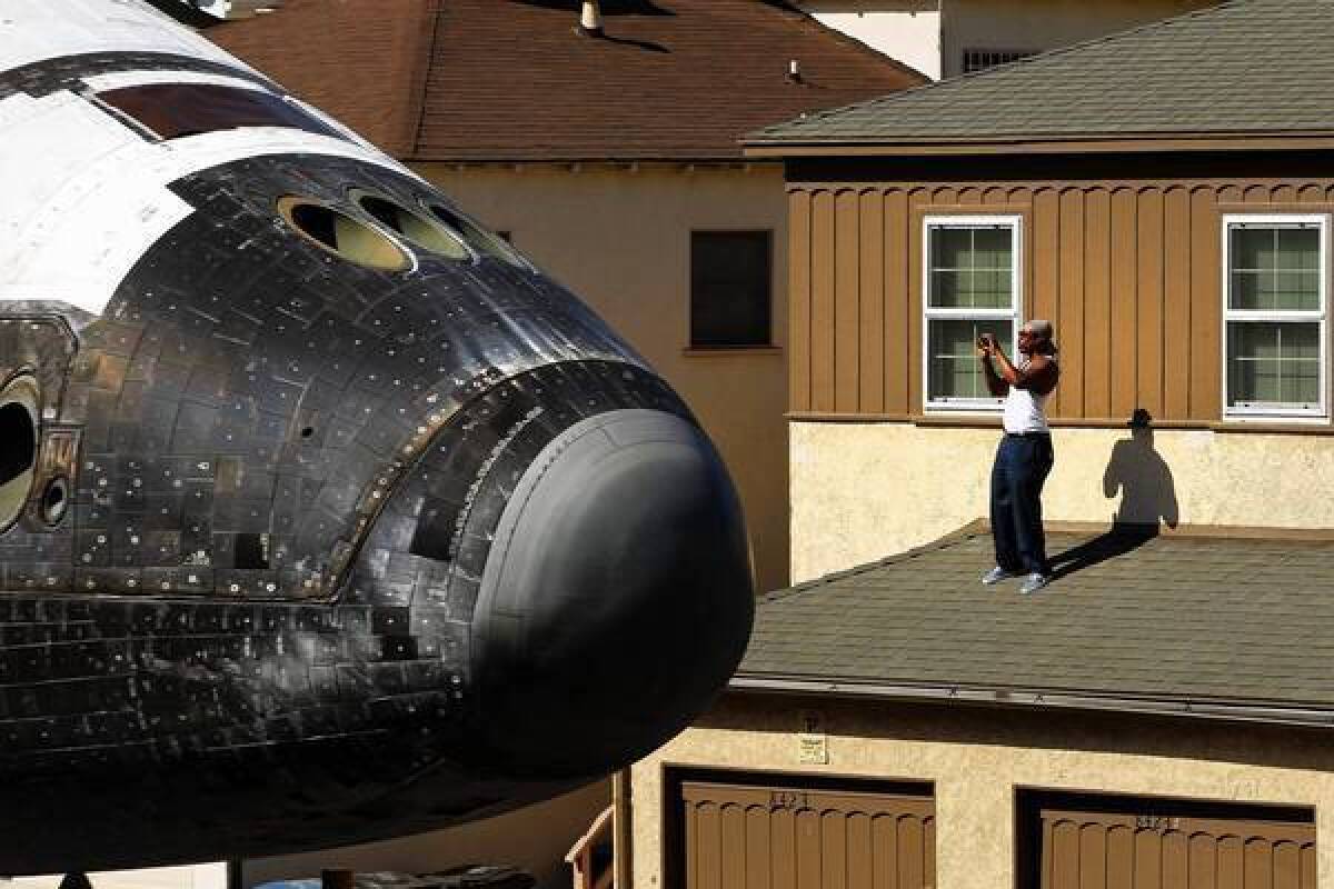 The space shuttle Endeavour travels the streets of Los Angeles on its way to the California Science Center in October. Since the shuttle fleet's retirement, NASA has no clear agenda for its human spaceflight division.
