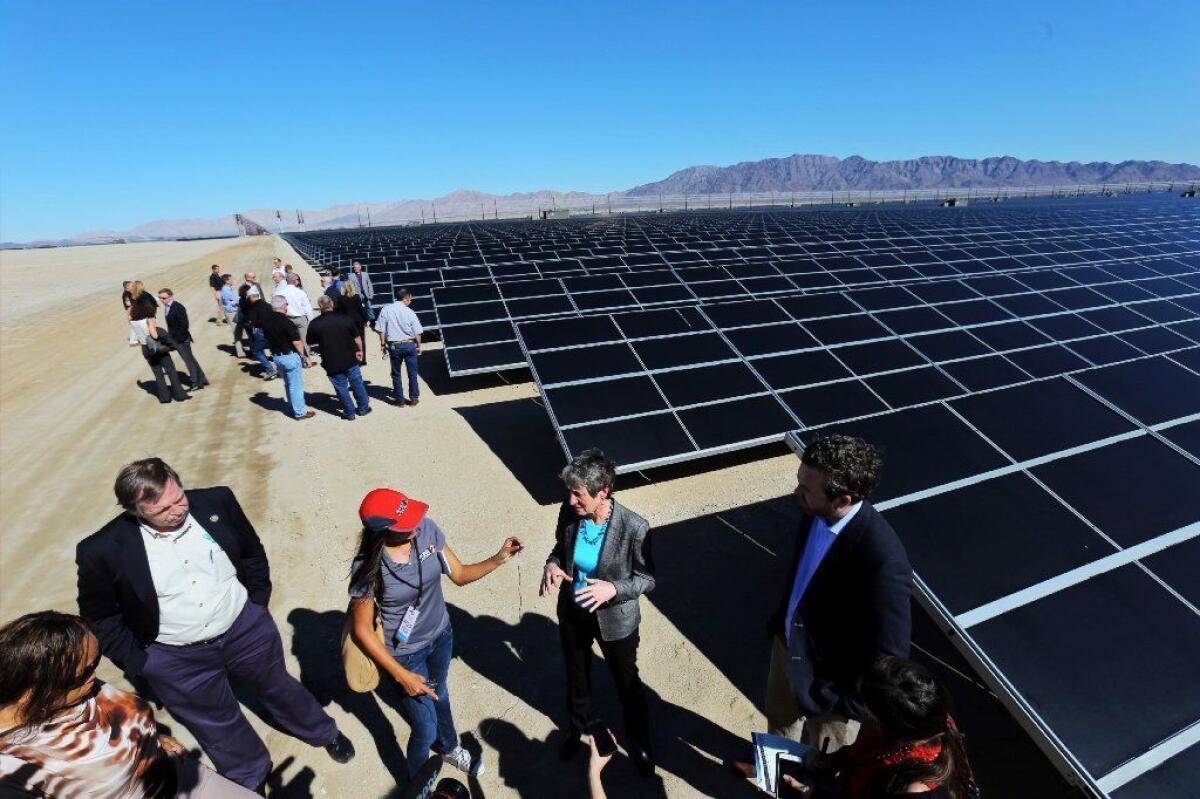 Obama administration Interior Secretary Sally Jewell, center, talks to reporters after the dedication ceremony for the 550-megawatt Desert Sunlight Solar Farm in 2015.