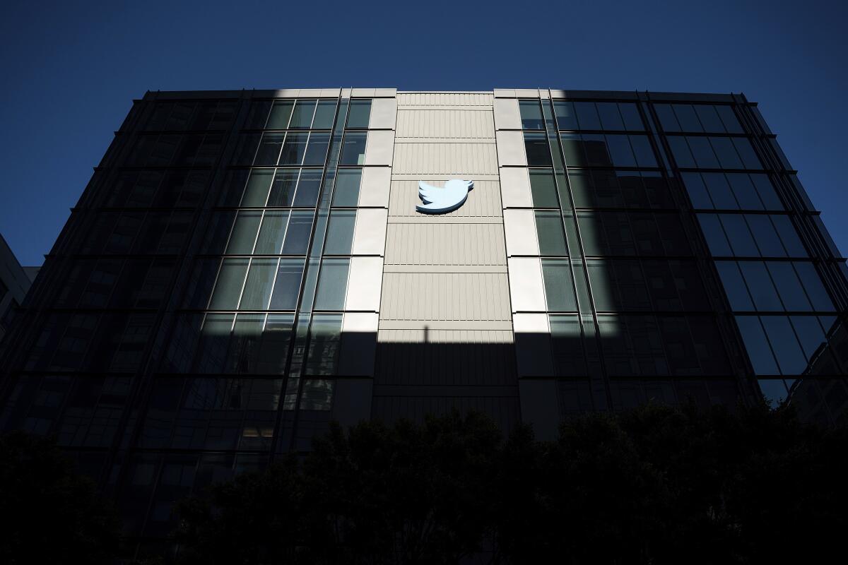 Twitter logo hangs outside the company's San Francisco offices on Nov. 1, 2022. 