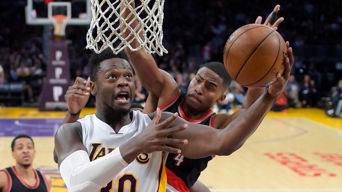 Lakers forward Julius Randle tries to score against Maurice Harkless during a 97-81 loss to the Trail Blazers on Sunday. (Mark J. Terrill / Associated Press)