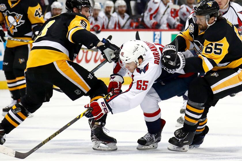 PITTSBURGH, PA - MAY 08: Andre Burakovsky #65 of the Washington Capitals skates between Brian Dumoulin #8 and Ron Hainsey #65 of the Pittsburgh Penguins in Game Six of the Eastern Conference Second Round during the 2017 NHL Stanley Cup Playoffs at PPG PAINTS Arena on May 8, 2017 in Pittsburgh, Pennsylvania. (Photo by Gregory Shamus/Getty Images) ** OUTS - ELSENT, FPG, CM - OUTS * NM, PH, VA if sourced by CT, LA or MoD **