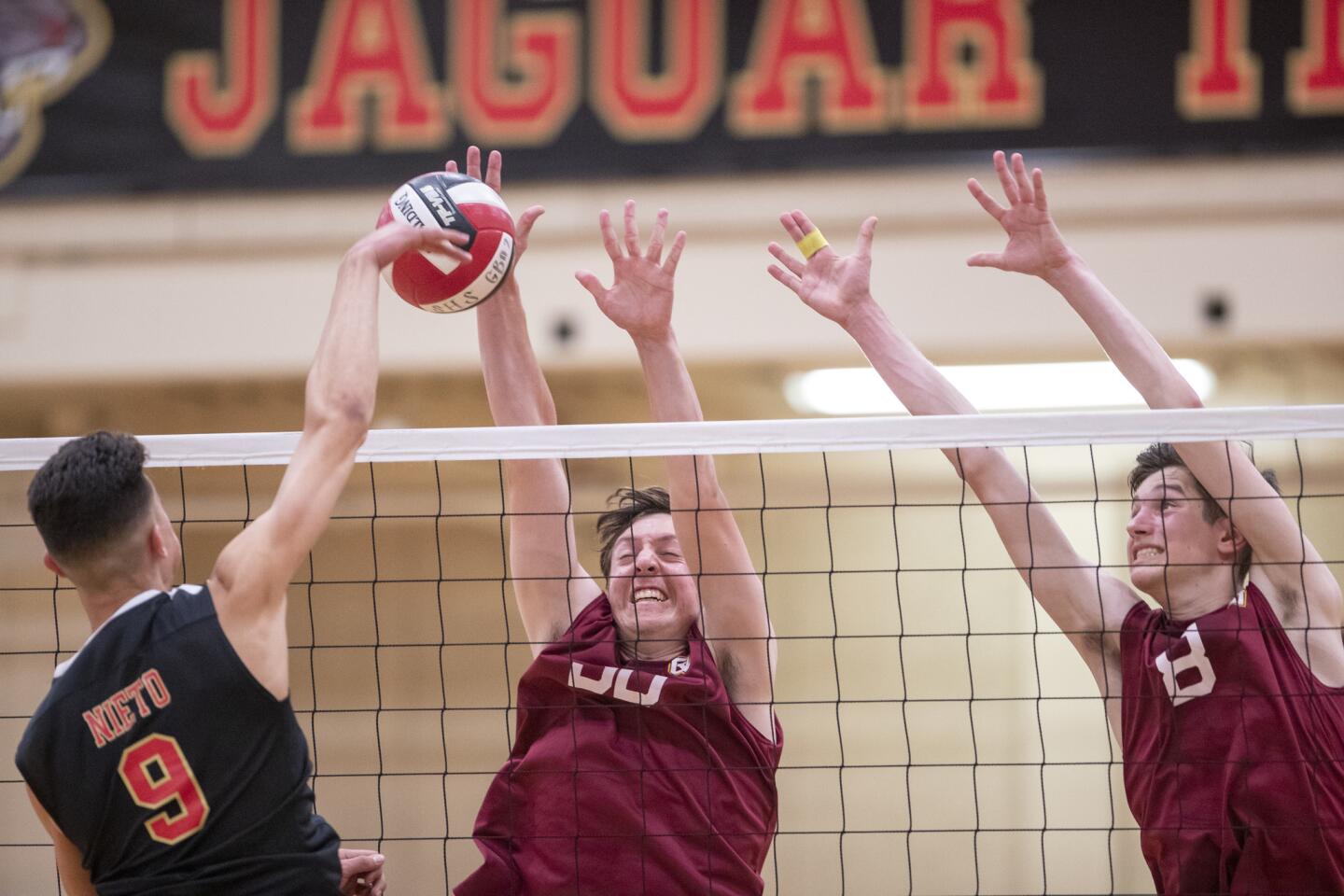 Ocean View High's Daniel Powell-Horan, center, and Jackson Petrovich attempt to block a ball from Segerstrom's David Nieto in a Golden West League match in Santa Ana on Tuesday.