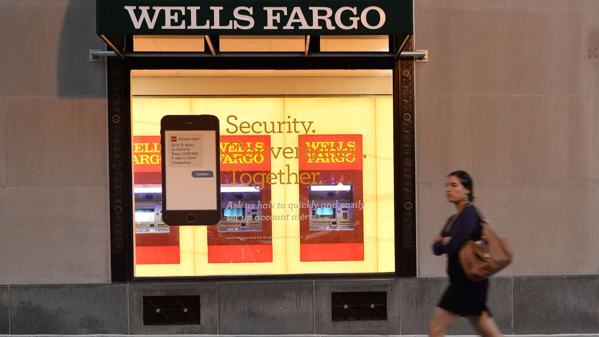 A woman walks past a Wells Fargo bank in Washington, D.C. on Oct. 5.