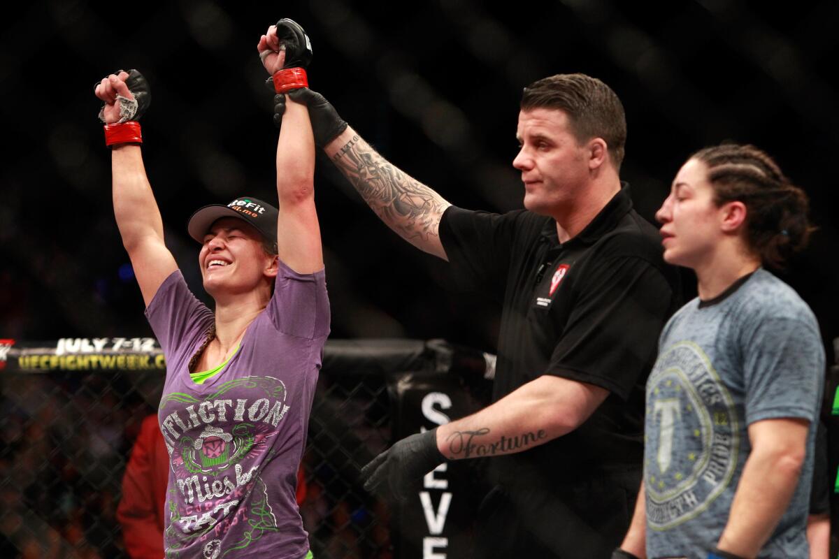 Miesha Tate is declared the winner over Sara McMann, right, in their bantamweight bout during UFC 183 at the MGM Grand Garden Arena on Jan. 31.