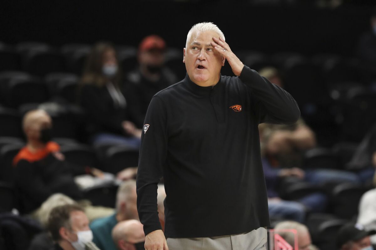 Oregon State coach Wayne Tinkle looks at the scoreboard at the start of a timeout during the second half of the team's NCAA college basketball game against California on Wednesday, Feb. 9, 2022, in Corvallis, Ore. California won 63-61. (AP Photo/Amanda Loman)