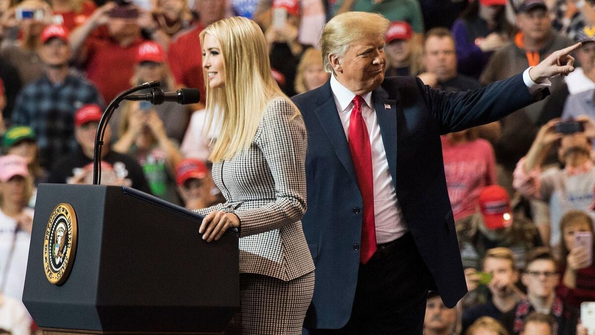 Ivanka Trump stands beside her father, President Trump, while speaking at a political rally in Cleveland on Monday.