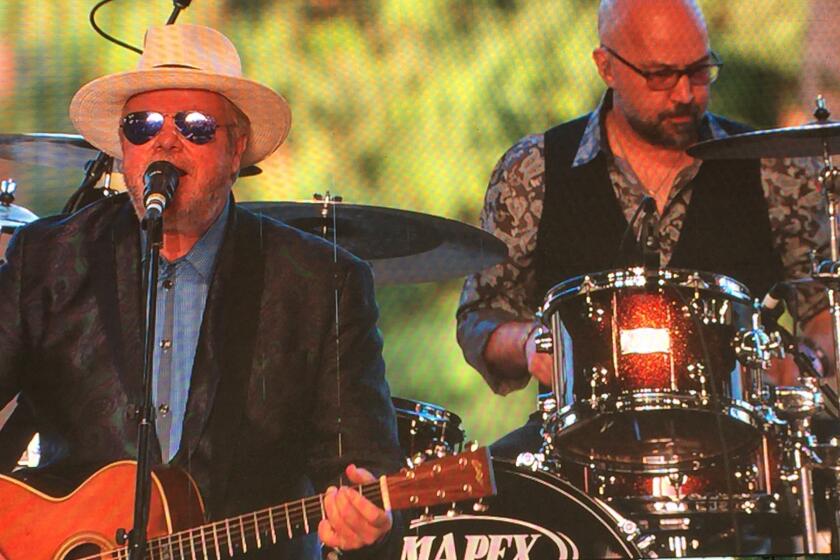 Texas singer-songwriter Robert Earl Keen, left, performs on Friday's opening day of the three-day Stagecoach Country Music Festival in Indio.