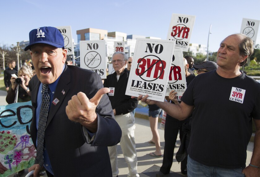 Former Los Angeles City Council member Bill Rosendahl, left, speaks out against the Santa Monica Airport during a rally outside City Hall on Tuesday evening.