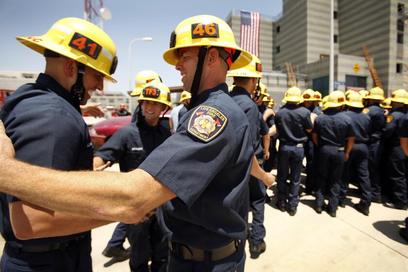 New LAFD firefighters shake hands at the recruit graduation ceremony in Panorama City on June 12.