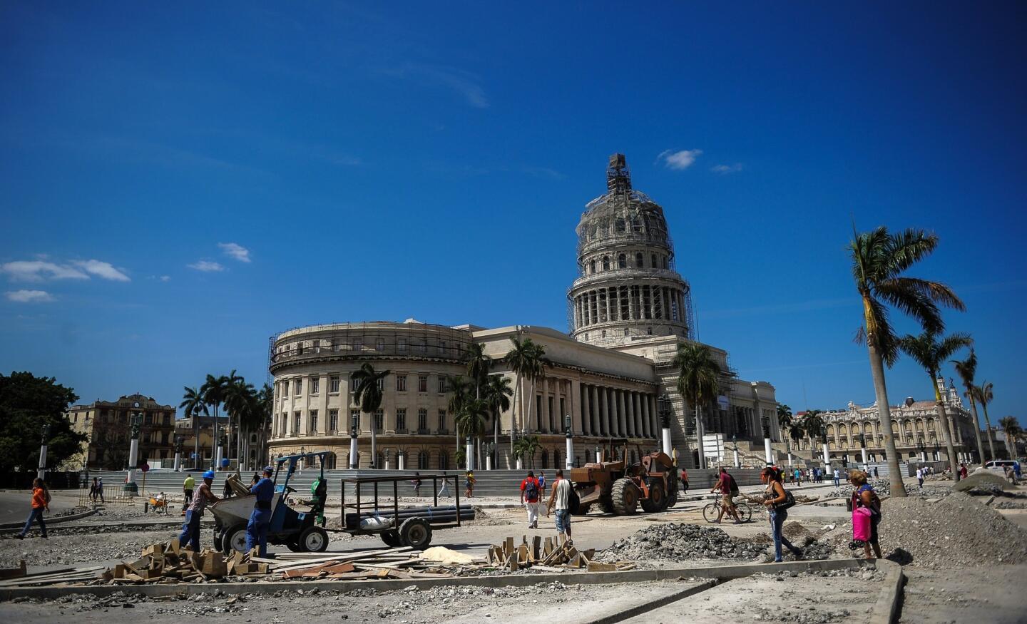 Workers repair a street near the Capitol in Havana, on March 16, 2016, during preparations ahead of President Barack Obama's visit.