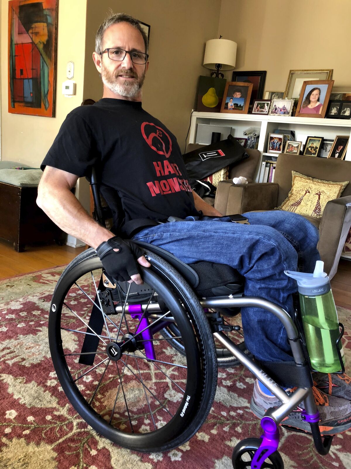 In this May 15, 2018 photo, Samuel Kolb poses for a photo in San Mateo, Calif. A Northern California county has agreed to pay nearly $10 million to settle a lawsuit by Kolb, who was going through a severe epileptic episode when a deputy shot him in the abdomen, paralyzing him from the waist down. (Karin Kolb via AP)