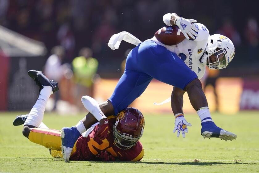 Southern California safety Calen Bullock, left, tackles San Jose State running back Tyler Nevens during the first half of an NCAA college football game Saturday, Sept. 4, 2021, in Los Angeles. (AP Photo/Ashley Landis)