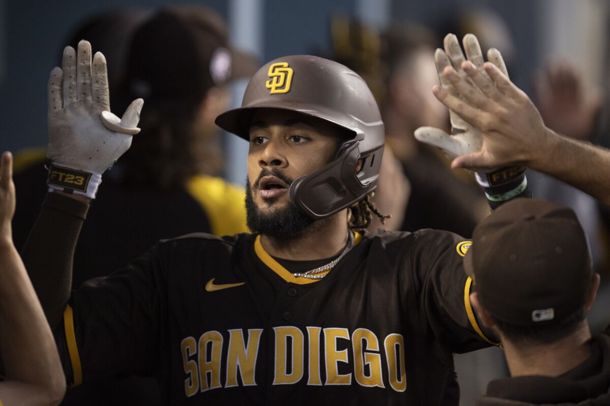 San Diego's Fernando Tatis Jr. celebrates in the dugout after hitting a two-run home run during the fourth inning.