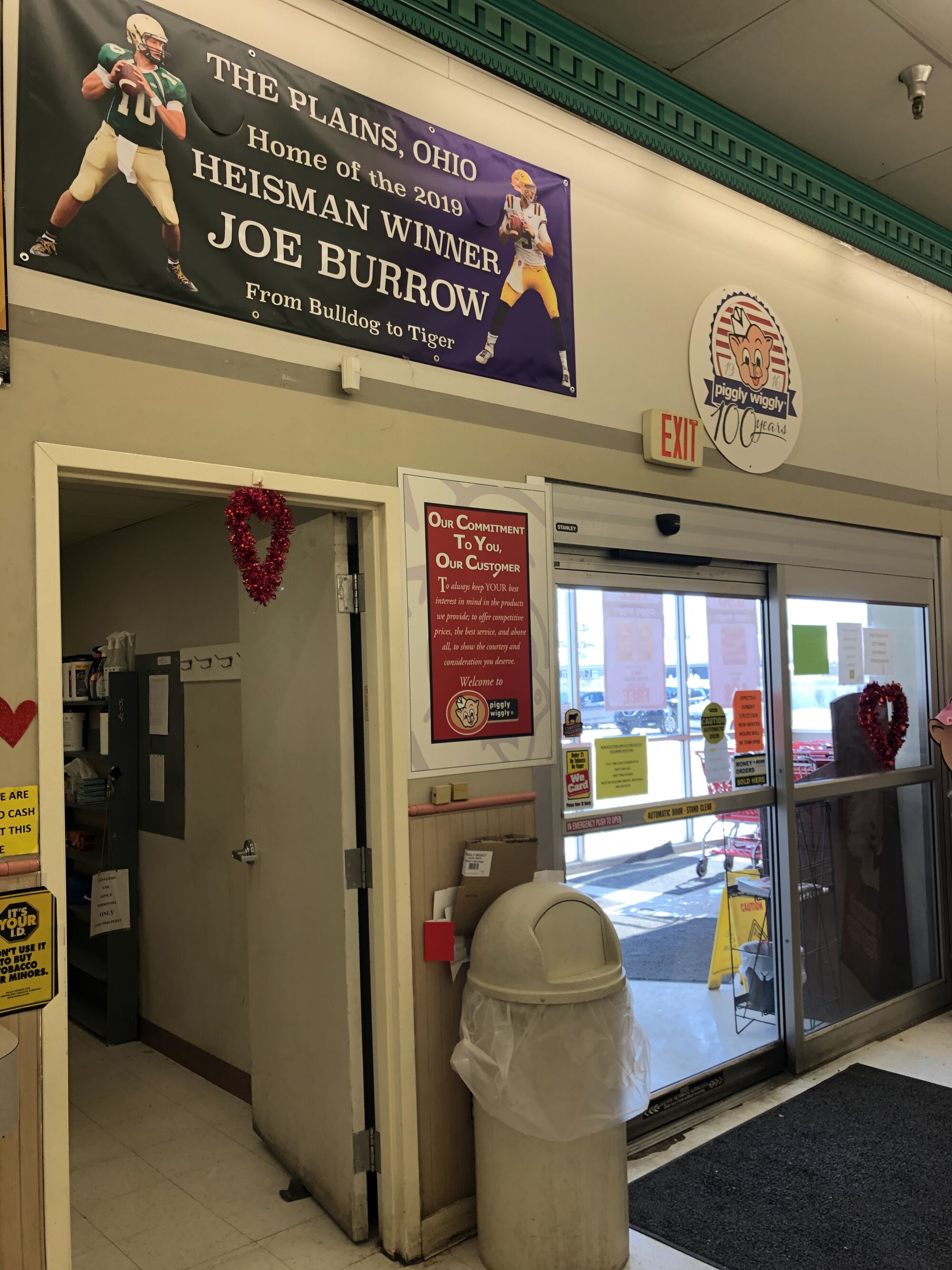 A sign above a grocery store door touts Joe Burrow's Heisman Trophy season 