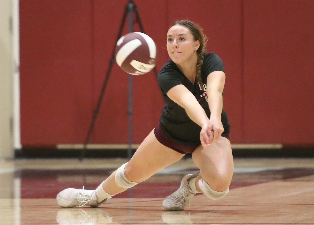 Laguna Beach's Hallie Carballo makes a diving dig to keep a long rally alive in the first round of the CIF Southern Section Division 1 playoffs at home against Mira Costa on Oct. 24.