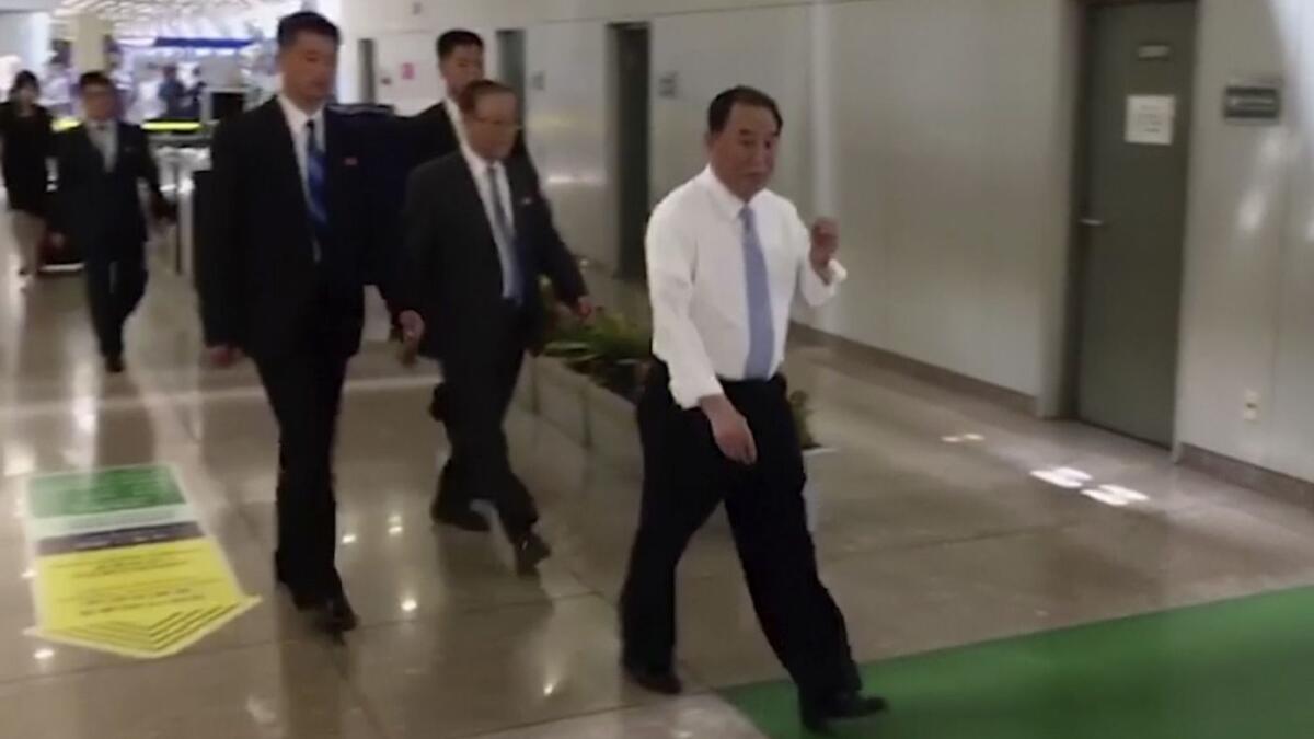 In an image from video, Kim Yong Chol, front, arrives at Beijing Capital International Airport on May 29.