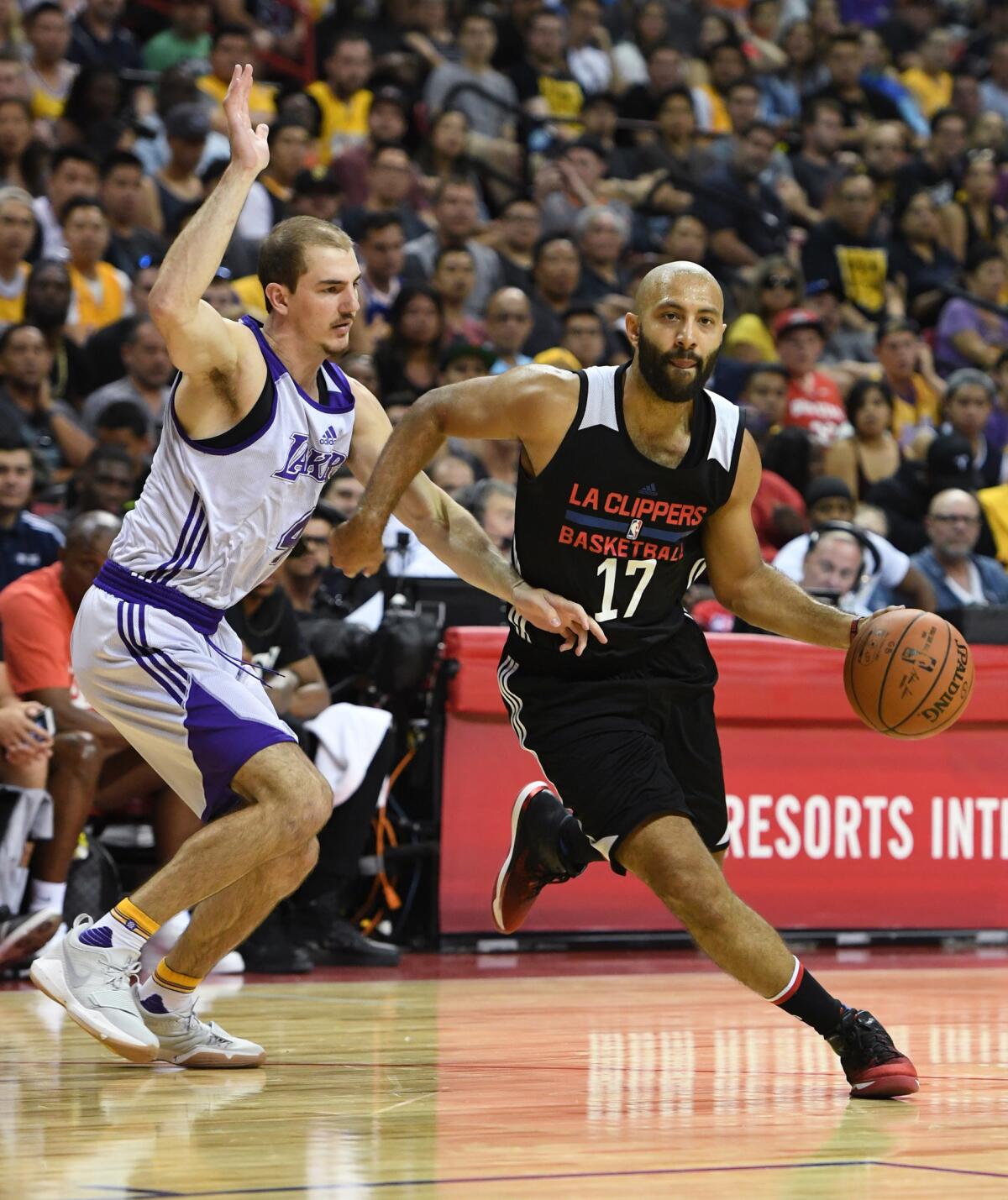 Kendall Marshall of the Los Angeles Clippers drives against Alex Caruso of the Los Angeles Lakers during the 2017 Summer League on July 7, 2017 in Las Vegas.